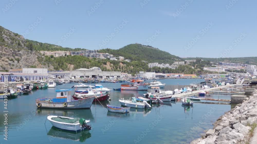 A Panning Shot of a Harbour full of Fishing Boats in a sleepy Portuguese town Sesimbra A Panning Shot of a Harbour full of Fishing Boats in a sleepy Portuguese town Sesimbra