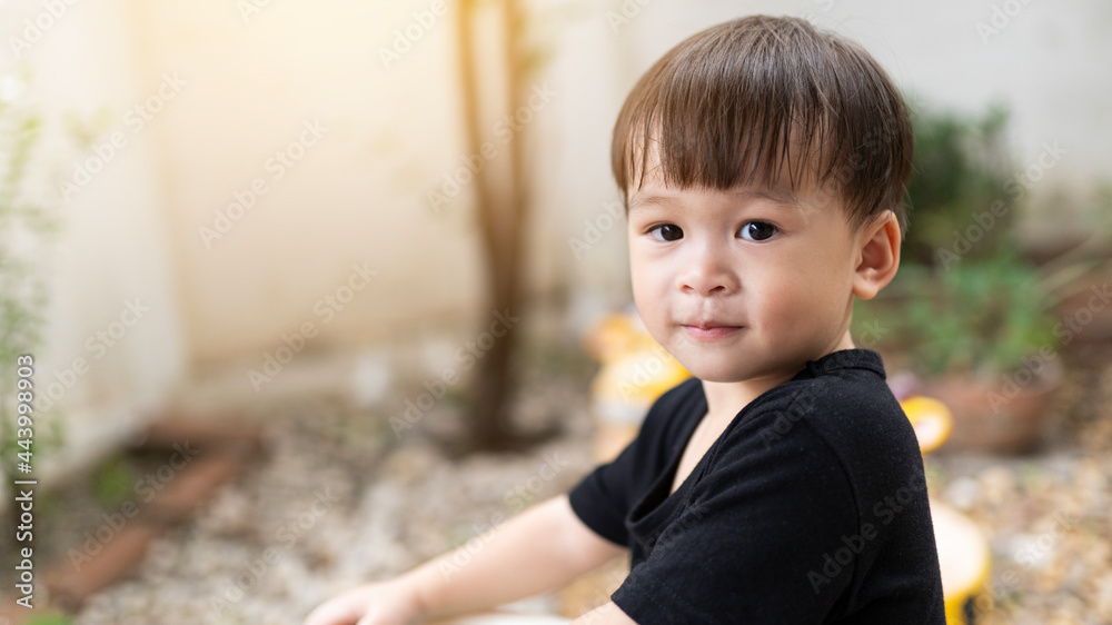 Close-up cute little Asian boy smiling happy outdoor. baby face, happy children playing in the morning. confident expression. The child's face shows confidence. Close-up cute little Asian boy smiling happy outdoor. baby face, happy children playing in the morning. confident expression. The child's face shows confidence.