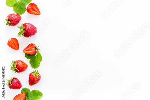 Fototapeta Naklejka Na Ścianę i Meble -  Red ripe strawberries with green leaves. Top view