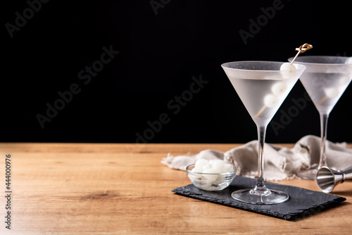 Fototapeta Gibson martini cocktail with onions on wooden table. Copy space