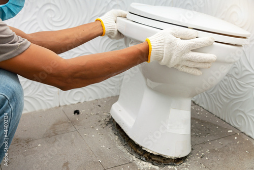 workerman performs repair of toilet bowl,  To repair the pipe from the toilet