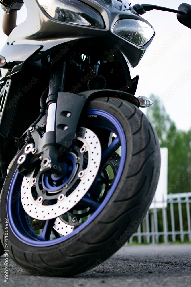 View of a sports charged motorcycle. with low profile rubber and chrome brakes. Vertical concept. View of a sports charged motorcycle. with low profile rubber and chrome brakes. Vertical concept.