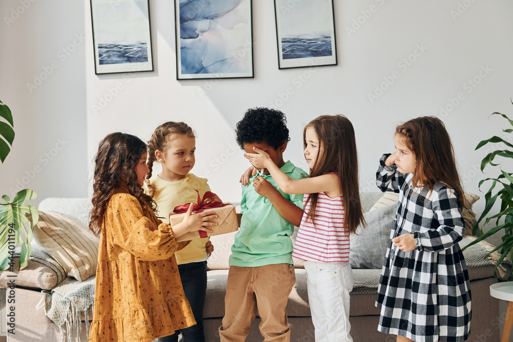 At home. Children on celebrating birthday party indoors have fun together At home. Children on celebrating birthday party indoors have fun together