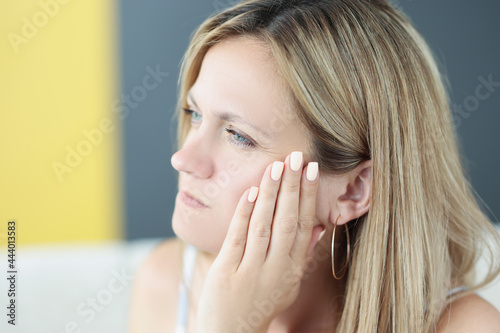 Portrait of young woman with toothache and inflammation of gums