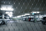 Underground parking. Cars parked in a garage with no people. Many cars in parking garage interior. Underground parking with cars (color toned image)