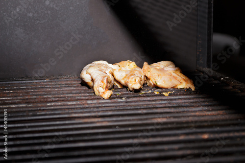 Chicken Barbecue. Seasoned raw food placed on the barbecue grill