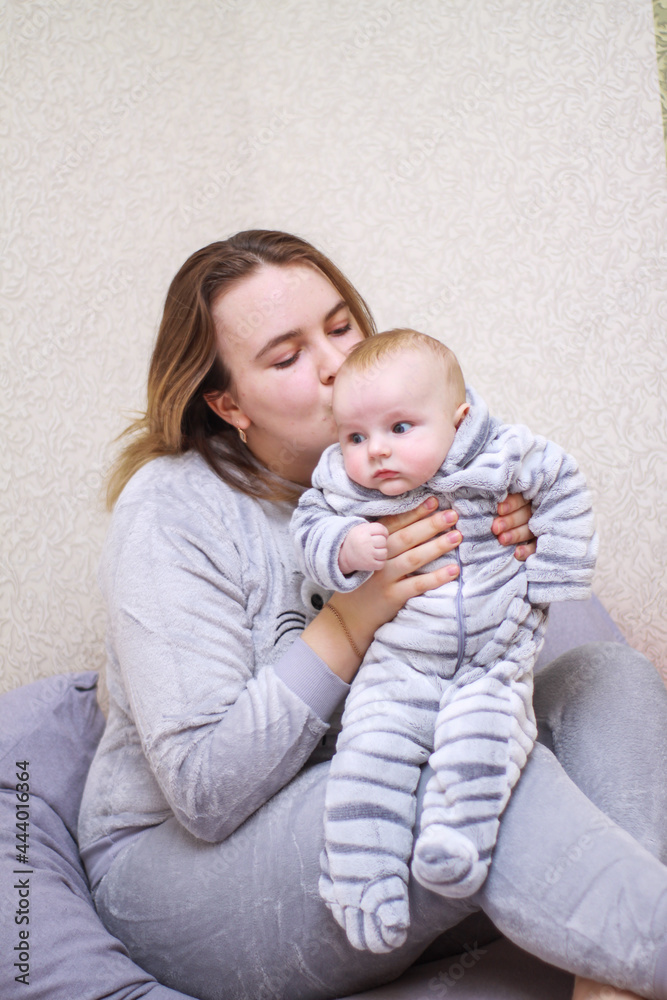 home photos of a young mother with a small child. Newborn boy. Cute, cozy photos with a baby.