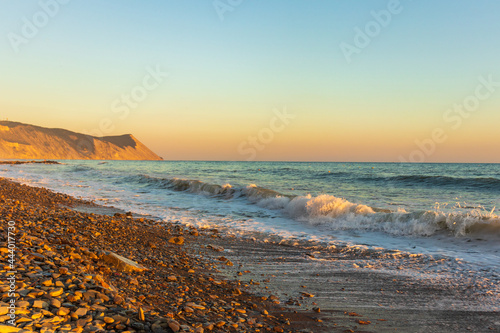 Dark blue waves against the beautiful orange sunset at the Black Sea, Anapa, Russia