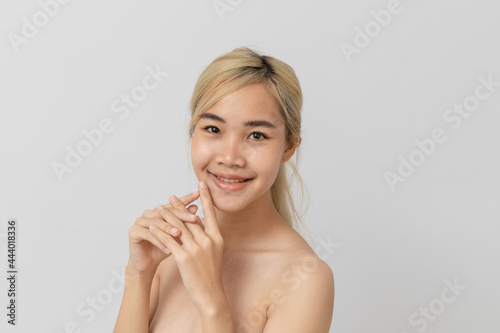 Beautiful Asian Woman with Clean Fresh Skin, on white background Face care.