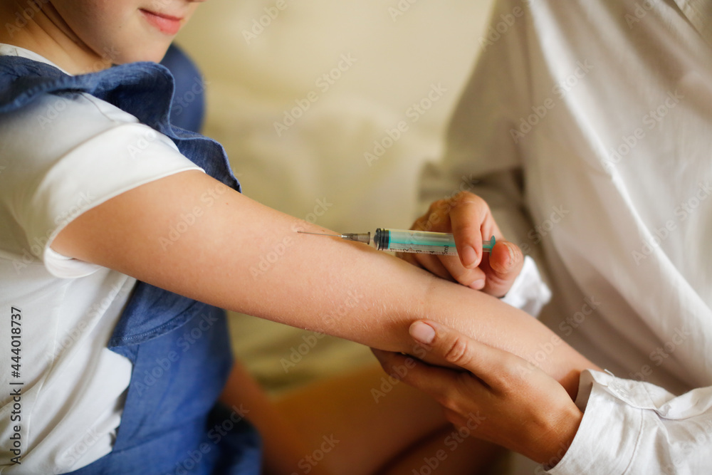 nurse in mask and white coat injects child girl with syringe, calling doctor at home, patronage. Treatment of pediatrician at home in real interior, the concept of medicine and disease prevention nurse in mask and white coat injects child girl with syringe, calling doctor at home, patronage. Treatment of pediatrician at home in real interior, the concept of medicine and disease prevention