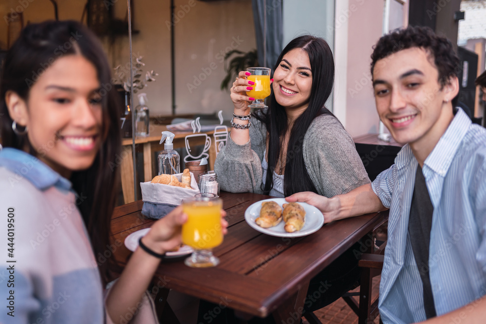 Portrait of a group of friends drinking juices at a bar. Portrait of a group of friends drinking juices at a bar.