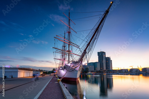 Harbor in Gdynia with the sailboat at sunset. Poland photo