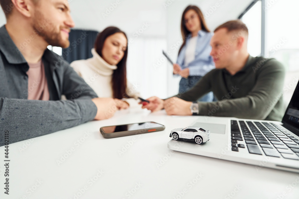 Doing handshake. Group of people works in the office by sitting by the table Doing handshake. Group of people works in the office by sitting by the table