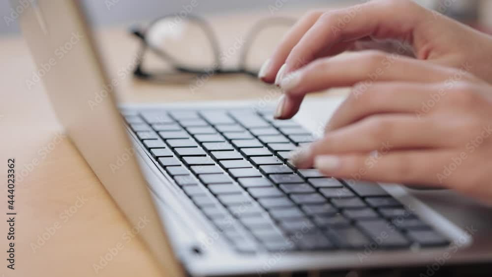 Close up young caucasian woman working on computer, using touchpad, typing corporate message, communicating with clients. Girl student doing homework university assignment on laptop Close up young caucasian woman working on computer, using touchpad, typing corporate message, communicating with clients. Girl student doing homework university assignment on laptop