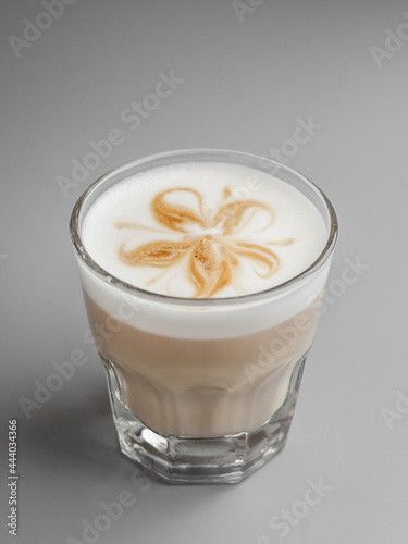 Delicious hot latte coffee with beautiful latte art in glass