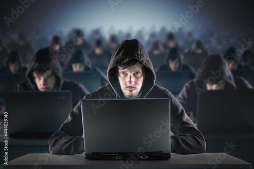 Many hackers in troll farm. Security and cyber crime concept.