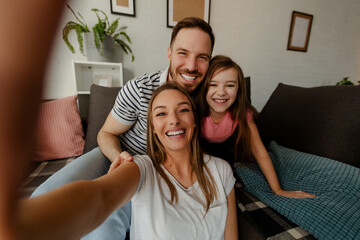 Happy family is having fun in living room. Family enjoying being together.