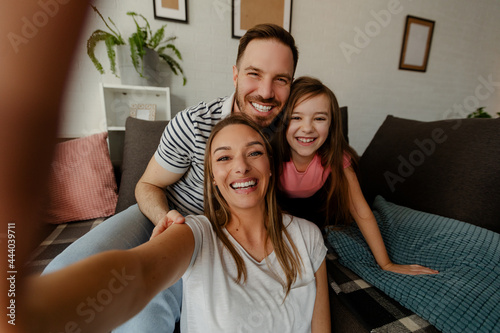 Happy family is having fun in living room. Family enjoying being together.