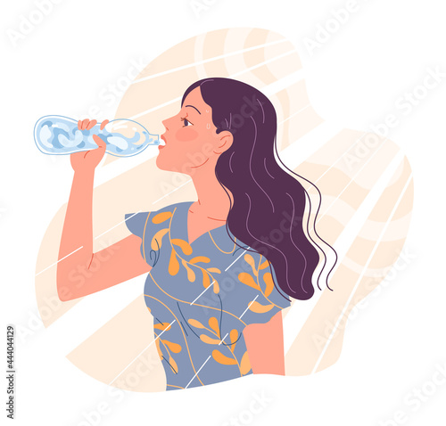 Young woman is thirsty in the heat and drinks water