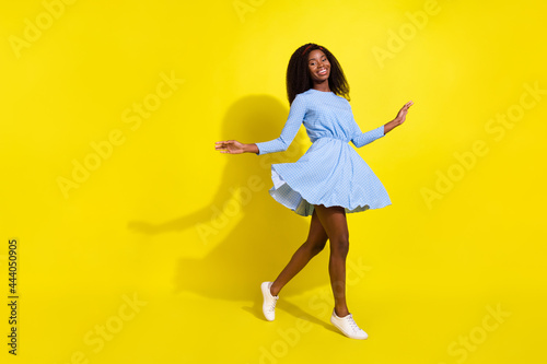 Full length photo of sweet young brunette hairdo lady dance wear blue dress isolated on yellow color background