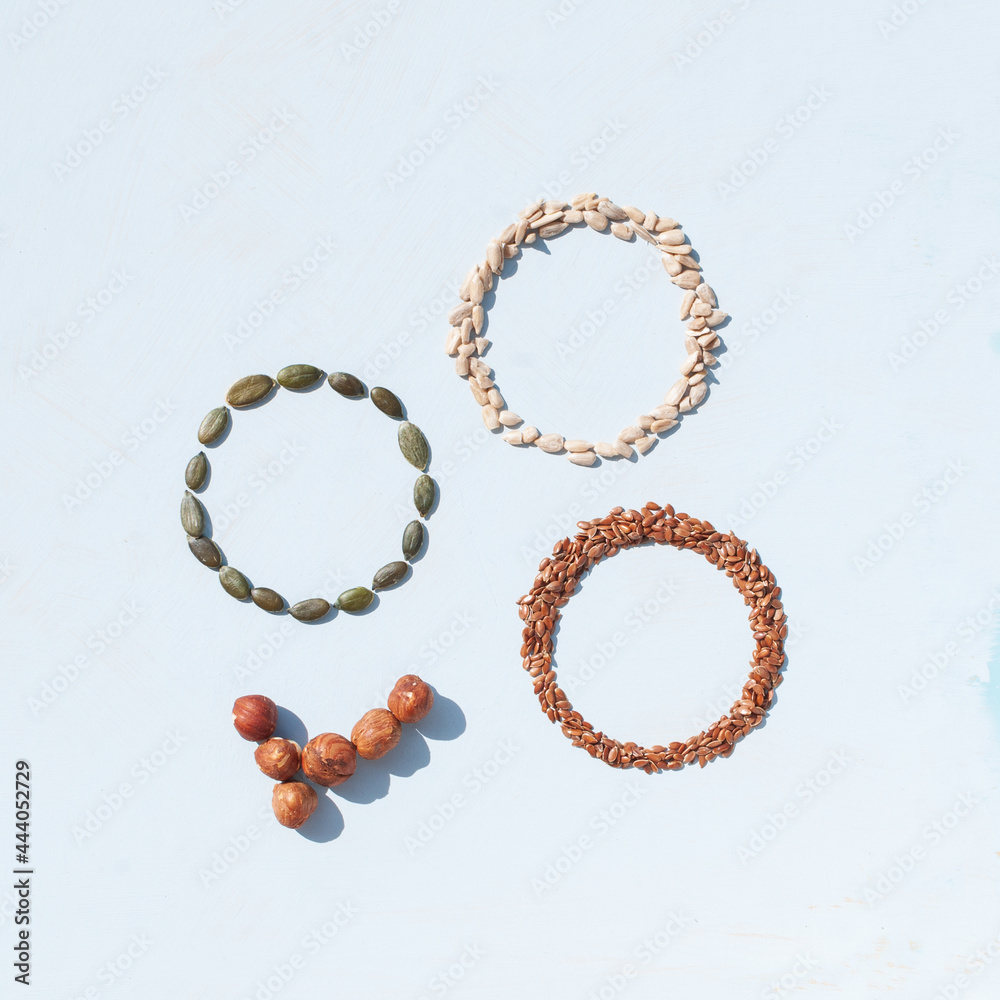 Circles made from different kinds of seeds on white background. Pumpkin seeds, sunflower seeds and linseed. Circles made from different kinds of seeds on white background. Pumpkin seeds, sunflower seeds and linseed.