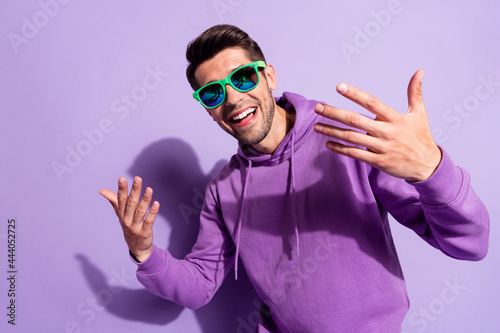 Photo portrait man smiling in sunglass dancing in nightclub on weekend isolated pastel purple color background