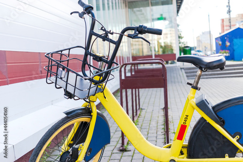 Bikesharing. Bicycles for rent. Bicycle in the bicycle parking near the store. Ecological urban transport. photo