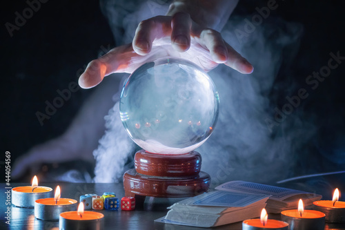Fotografie Magician or fortune teller is predicting future with crystal sphere