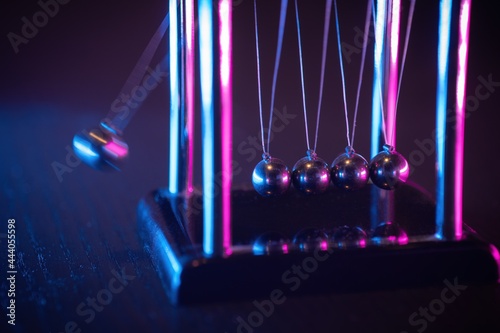 Newton cradle. Demonstrating gravity, action and reaction principle. photo