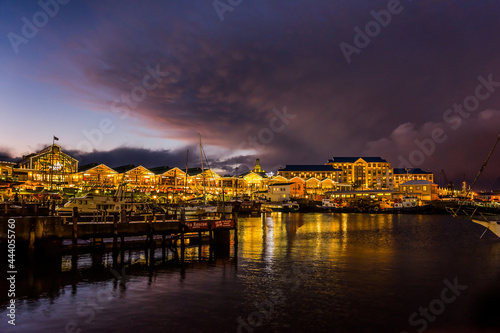 Victoria and Alfred Waterfront, harbor with recreation boats, shops and restaurants in the evening. Cape town, South Africa.
