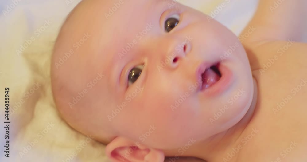 cute little baby lying in bed. close-up.view from above. cute little baby lying in bed. close-up.view from above.