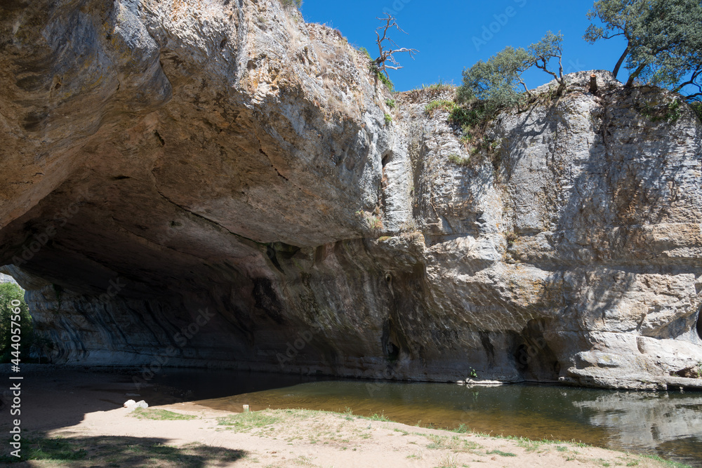 Natural bridge of rock over the river at Puentedey. Bathing area. Merindades, Burgos, Spain, Europe