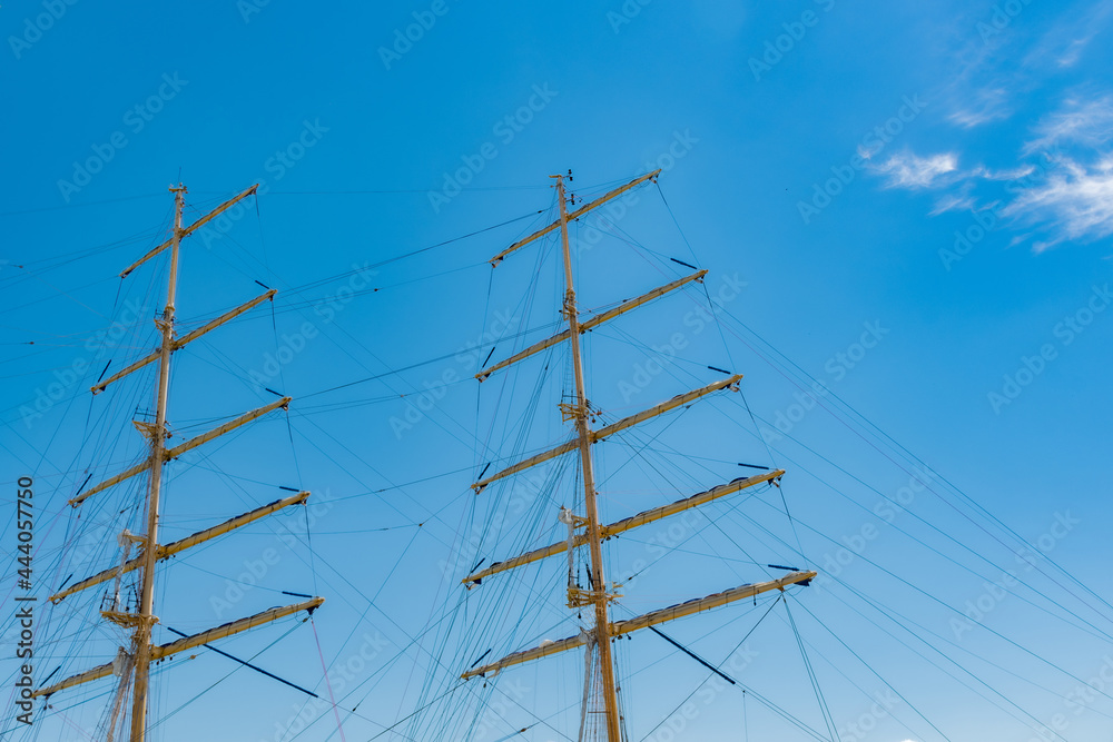 Ship masts against the sky in the sunlight, background Ship masts against the sky in the sunlight, background