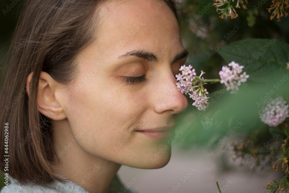 close up portrait of a woman eyes closed smelling flowers and smiling close up portrait of a woman eyes closed smelling flowers and smiling