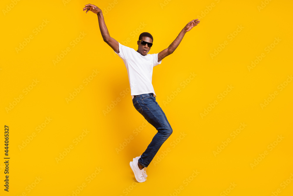 Full length body size view of attractive funky carefree guy dancing having fun good mood isolated over bright yellow color background