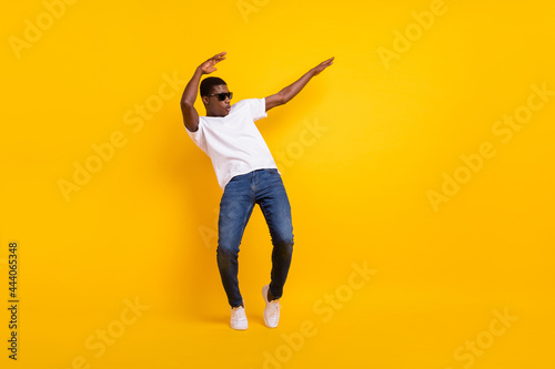 Full length body size view of attractive cheerful guy dancing pout lips having fun isolated over bright yellow color background