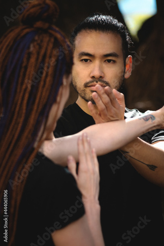 couple practicing kung fu in the park