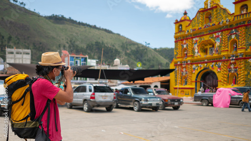 Portrait of a photographer taking a photo of the church of San Andrés Xecul Totonicapán. photo