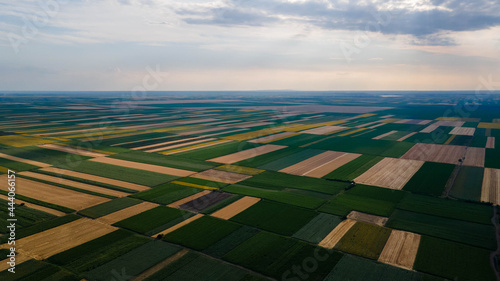 Birds Eye View of the Fields and Agricultural Parcel. Aerial Views. Aerial top view of a different agriculture fields in countryside on a summer day. Drone shot