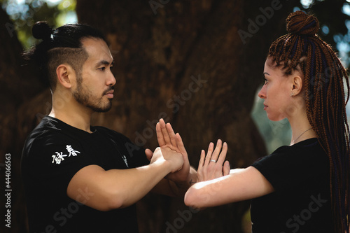 couple practicing kung fu in the park
