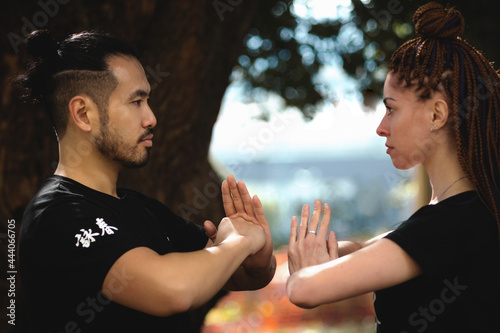 couple practicing kung fu in the park