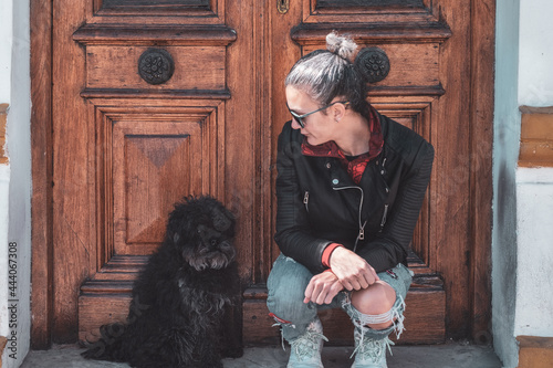 Girl talking to her dog sitting by the door