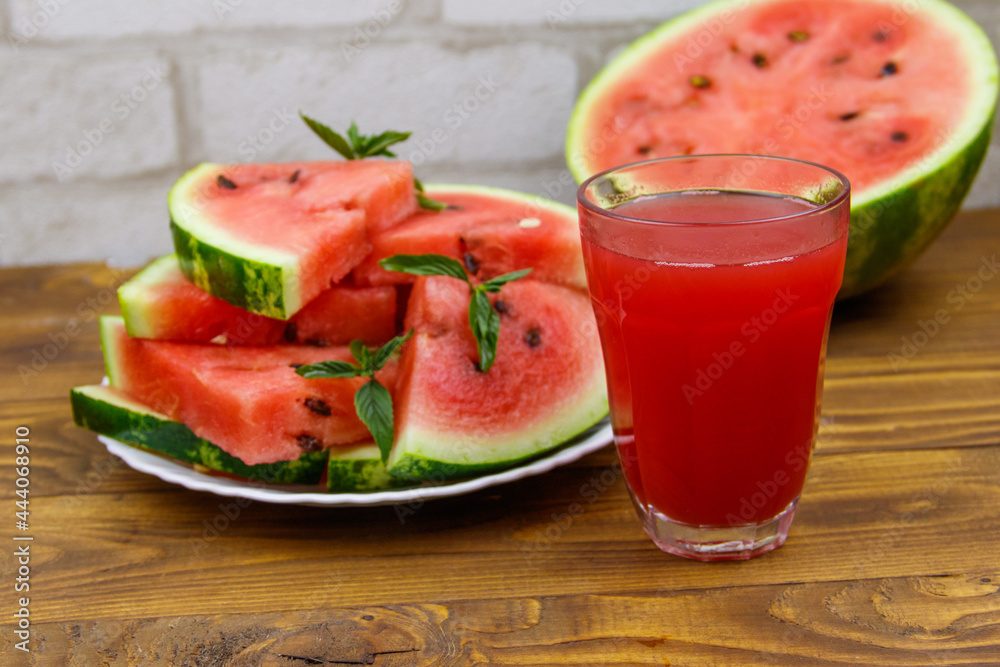 Glass of fresh watermelon juice on a wooden table Glass of fresh watermelon juice on a wooden table