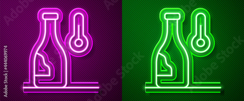 Glowing neon line Wine temperature icon isolated on purple and green background. Vector