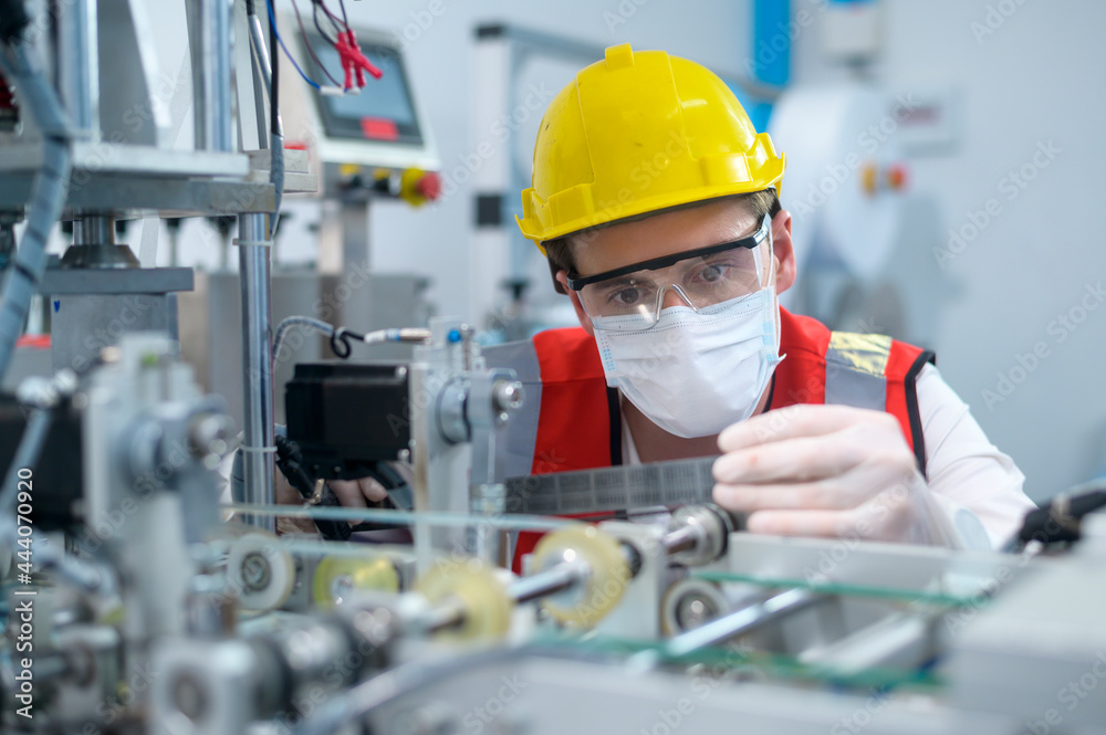 Quality control (QC) engineer monitoring and checking machine system in manufacturing factory