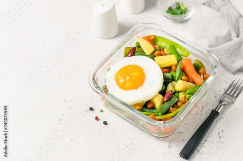 Healthy eating, meal prep, egg spring vegetables in glass container. Space for text.
