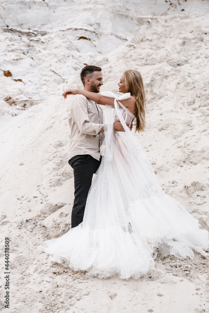 Beautiful wedding couple bride and groom at wedding day outdoors at ocean beach. Happy marriage couple o