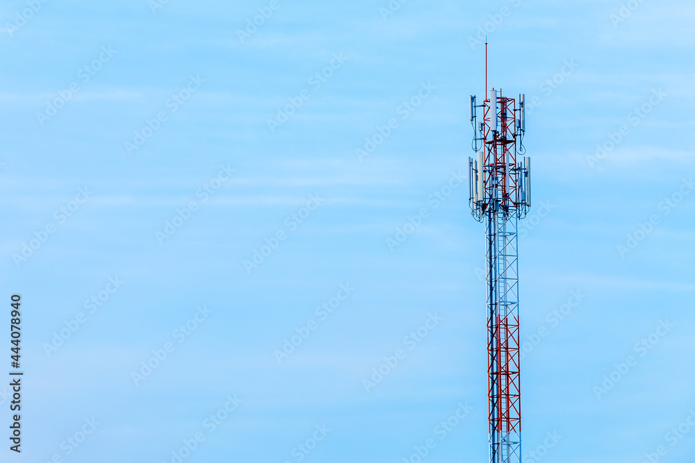 Mobile station receiver antenna tower with fluffy clouds blue sky daylight background. Mobile station receiver antenna tower with fluffy clouds blue sky daylight background.