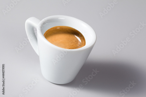 Espresso Coffee from Italy, Isolated on Gray Background – Original Creamy Arabica Coffee in Traditional White Marble Cup, with Shadow, Focus on Cream – Detailed Close-Up Macro, High Resolution