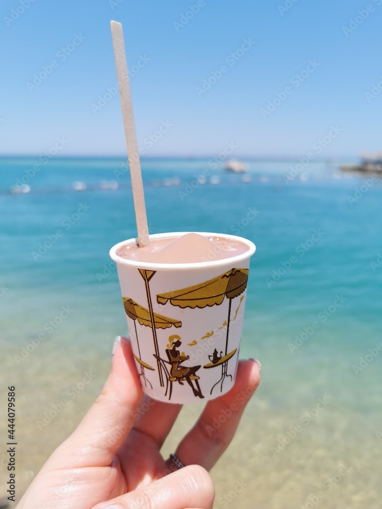 A glass of ice cream on the background of the red sea A glass of ice cream on the background of the red sea